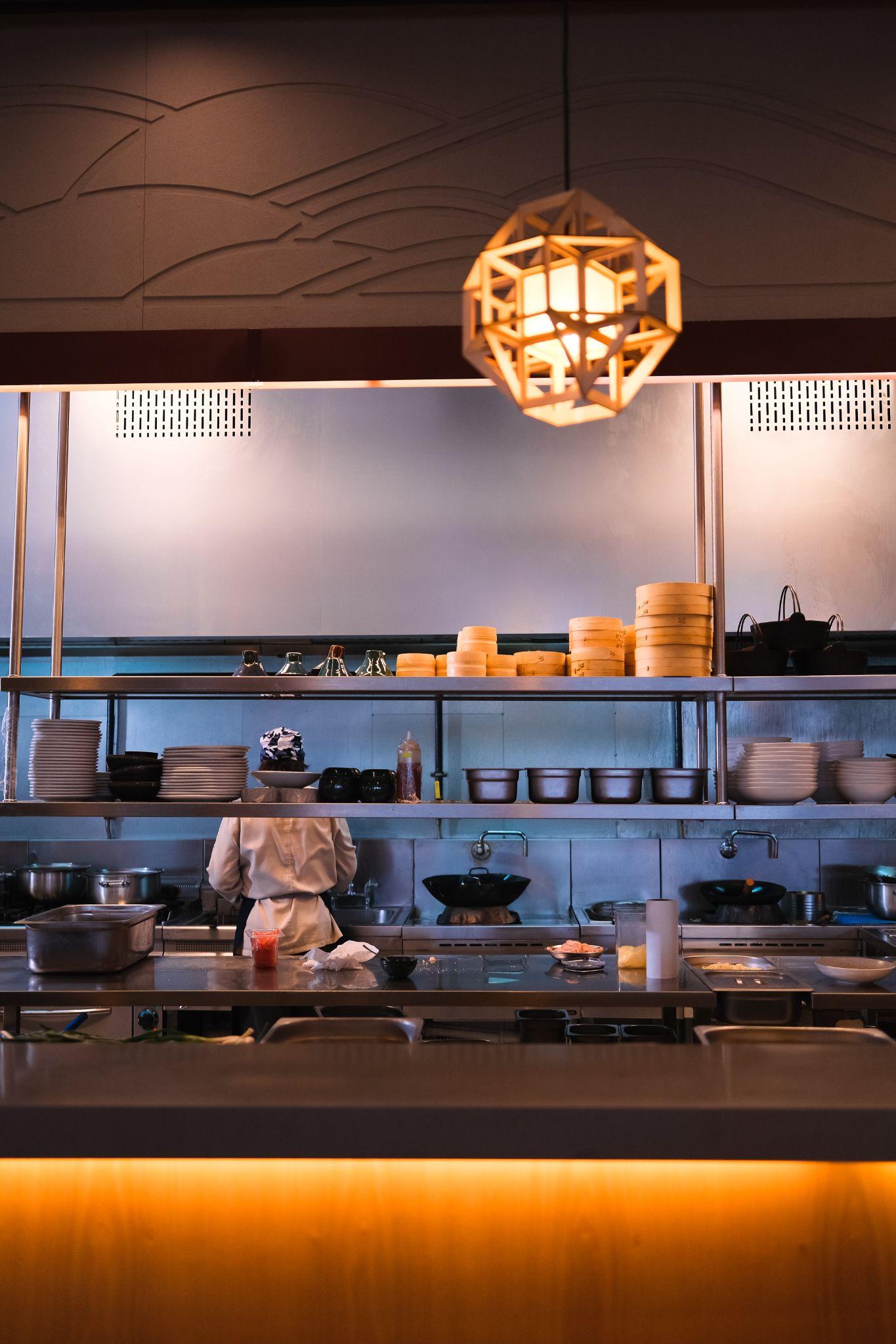 Open kitchen pass with stacked bamboo steamers